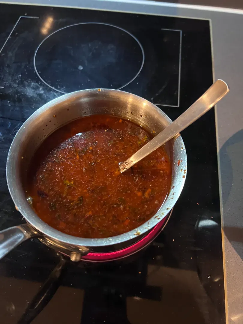 Red chilli oil in the small saucepan with the kombu dashi added