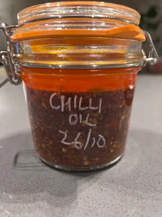 Mason jar of chilli oil labelled CHILLI OIL 26/10